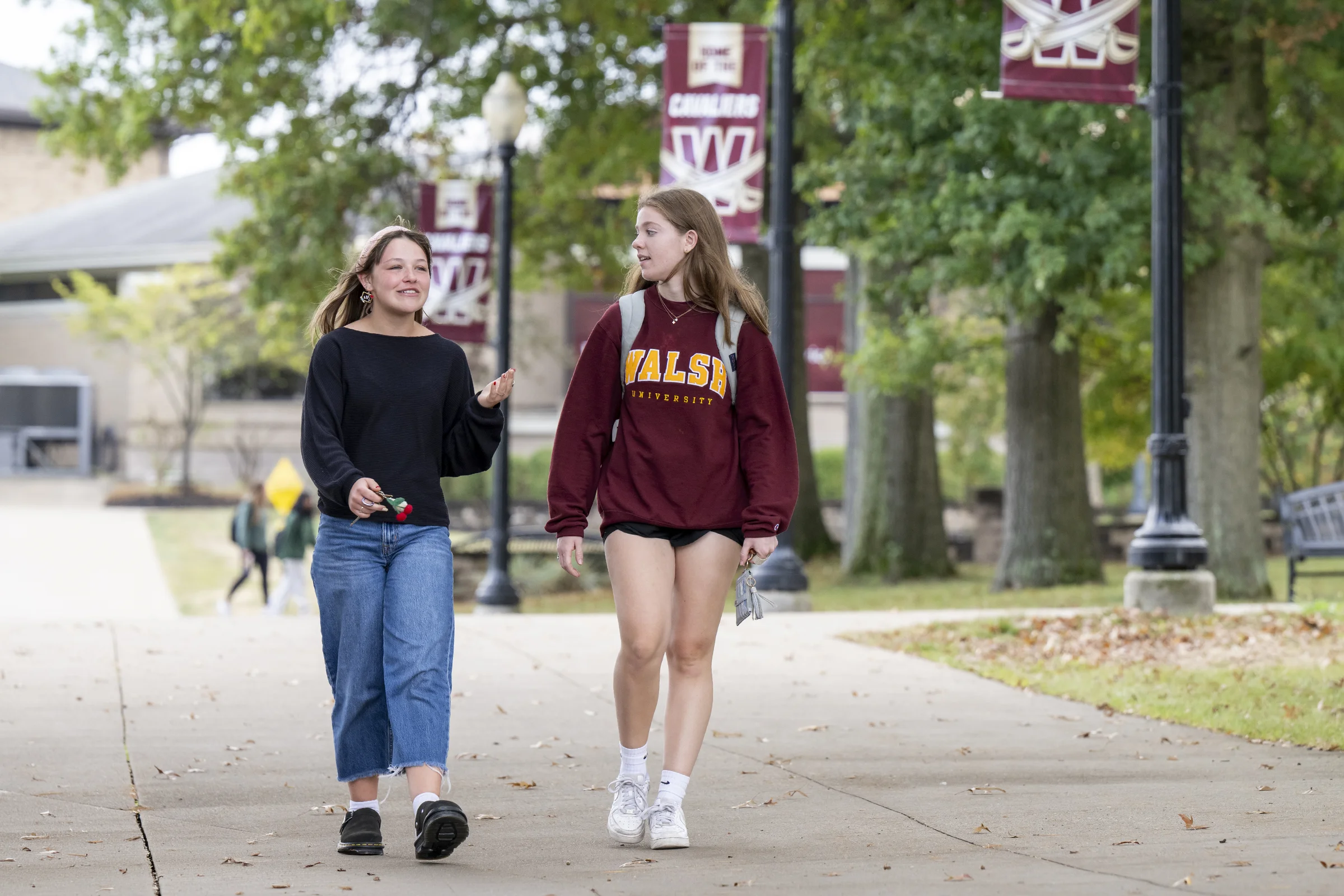 Two students walking through campus