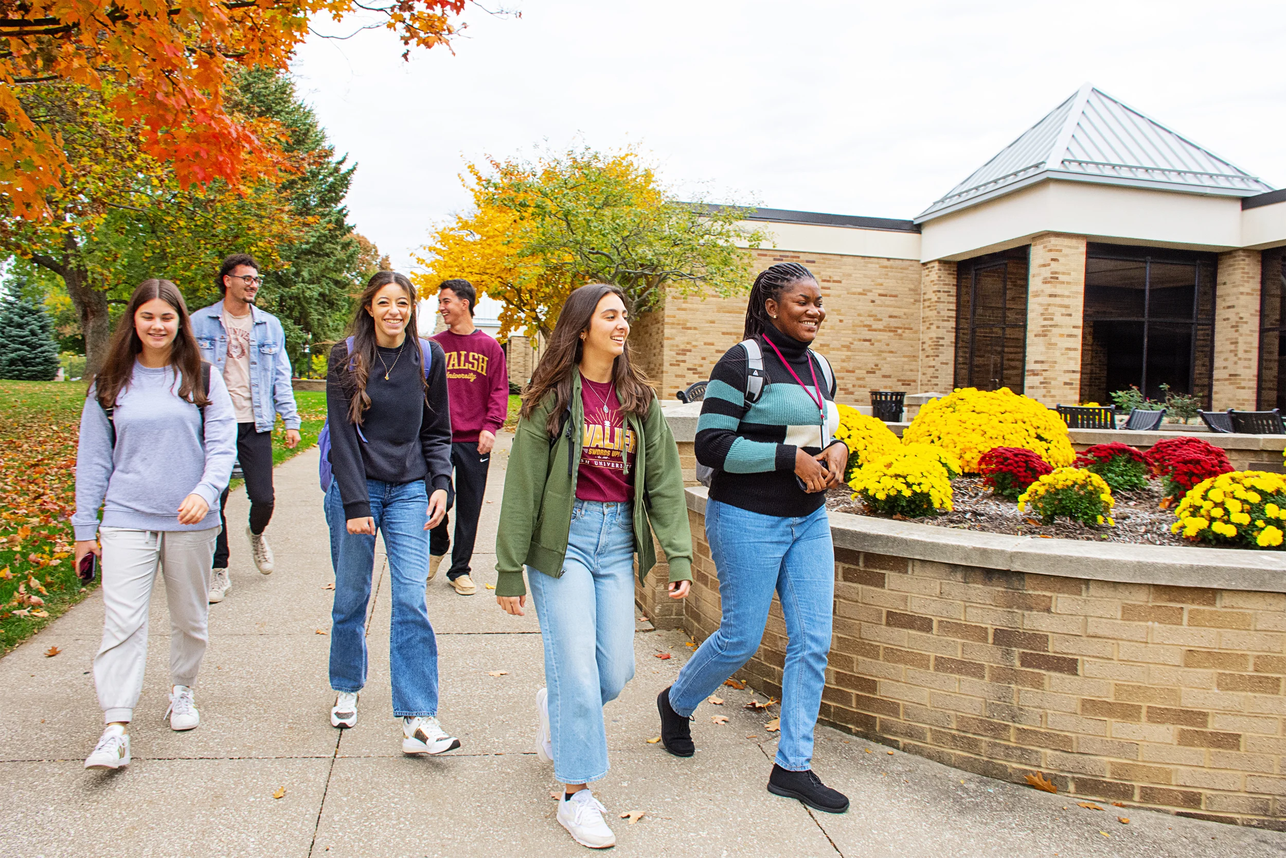 Walsh University students walking past the Barrette Business and Community Center
